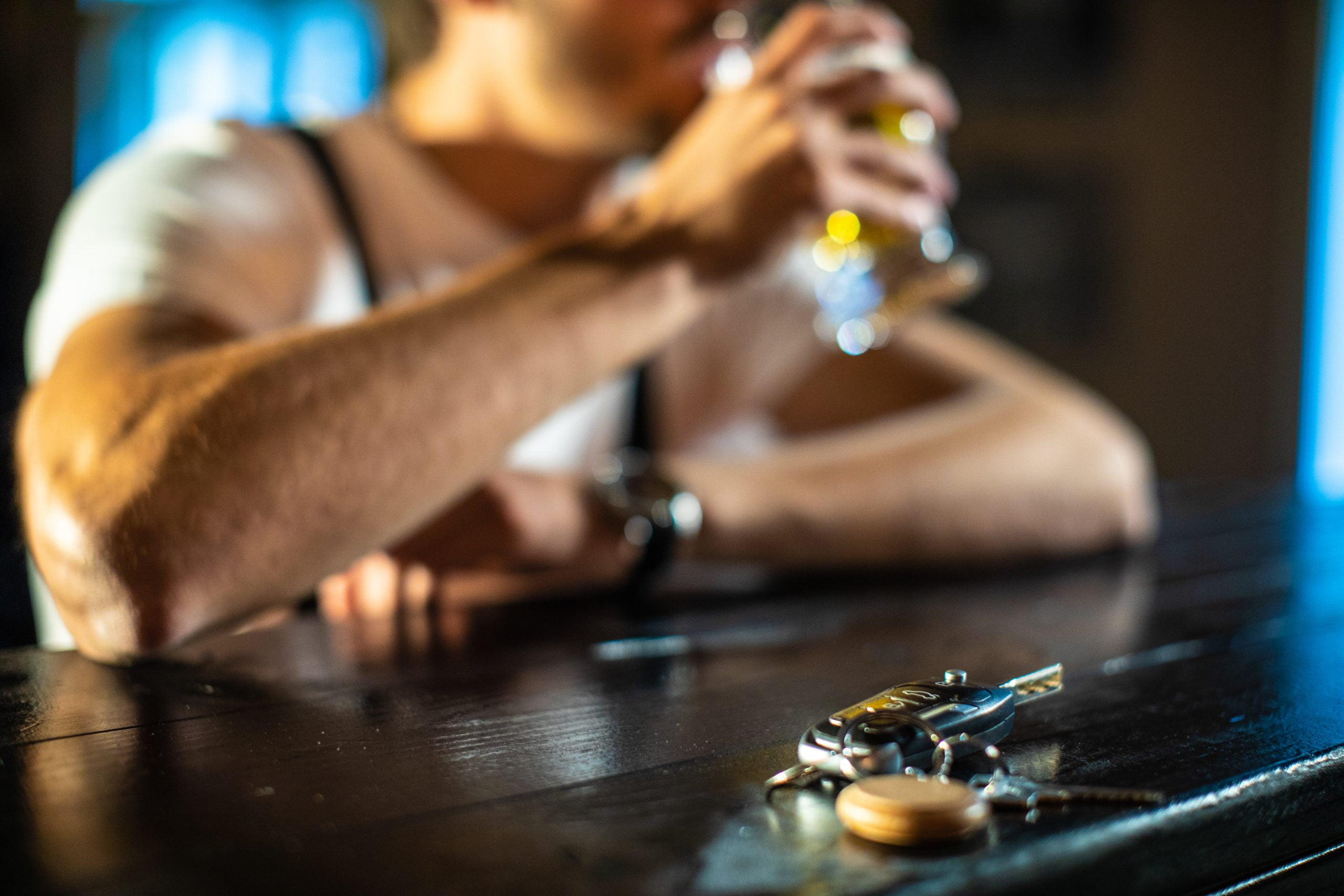 Man drinking at bar with car keys