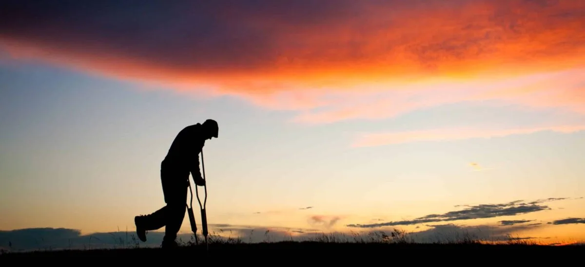 An injured man struggles to walk a small distance with crutches on after a slip and fall injury in Odessa, Texas.