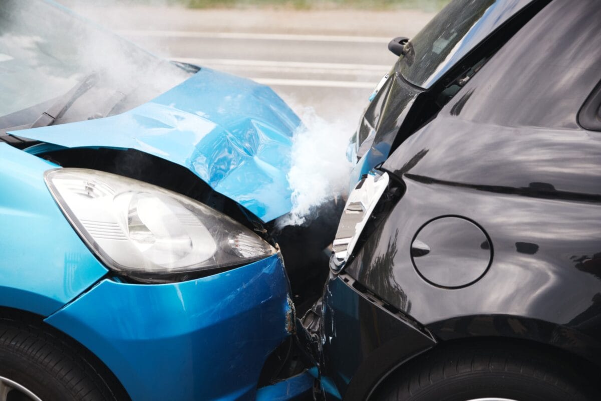 Close up of two damaged cars after a rear-end collision.